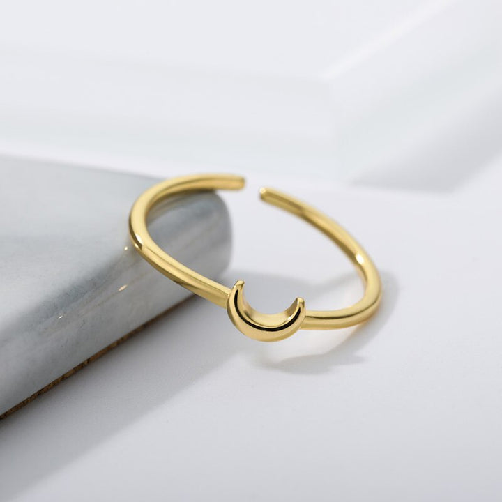 Adjustable minimalist crescent ring for women, perfect for stacking. Elegant gold or silver tone jewelry.