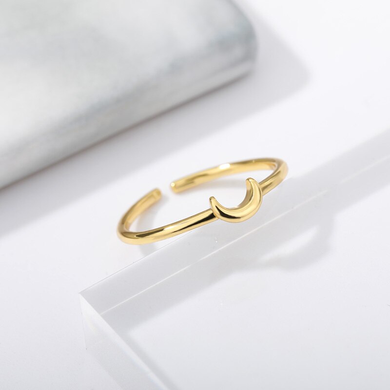 Chic minimalist crescent ring, a women's elegant fashion accessory. Adjustable gold/silver tone Nova ring.