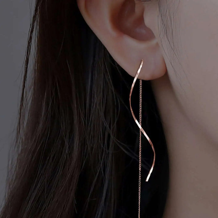 Elegant gold wave threader earrings for women, modern and stylish jewelry.