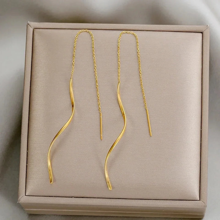 Artistic gold wave threader earrings, elegant and lightweight women's jewelry piece.