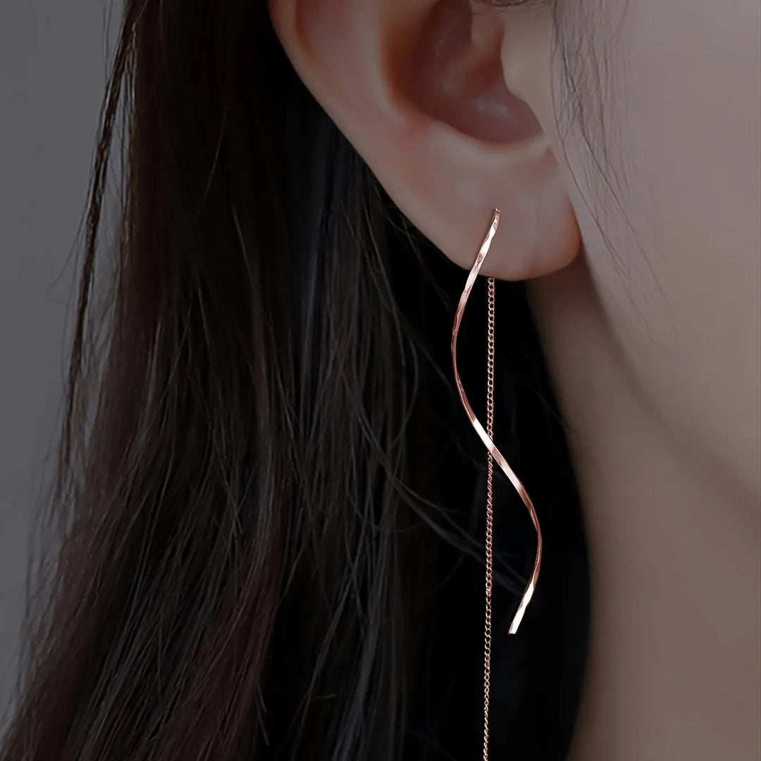 Rose gold wave threader earrings, delicate and elegant women's fashion accessory.
