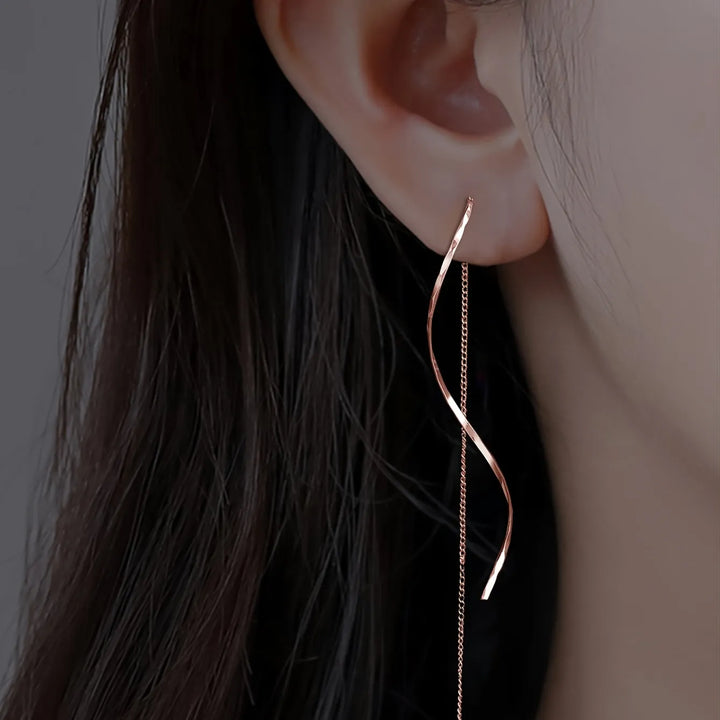 Rose gold wave threader earrings, delicate and elegant women's fashion accessory.