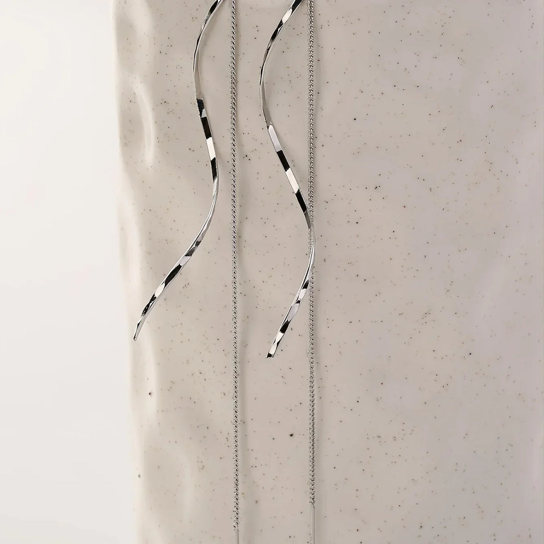 Modern stainless steel wave threader earrings, chic and sophisticated women's jewelry.