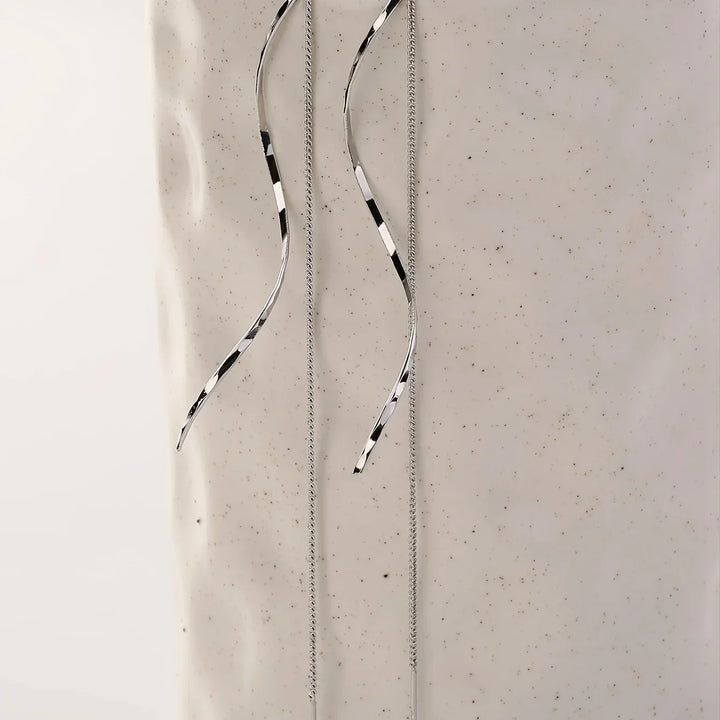 Modern stainless steel wave threader earrings, chic and sophisticated women's jewelry.