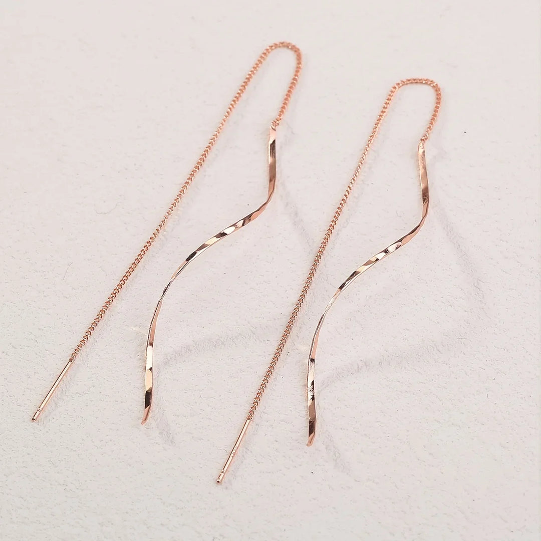Women's gold wave threader earrings, contemporary elegant design for any occasion.
