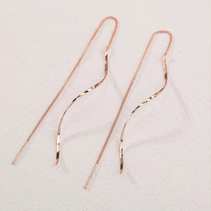Women's gold wave threader earrings, contemporary elegant design for any occasion.