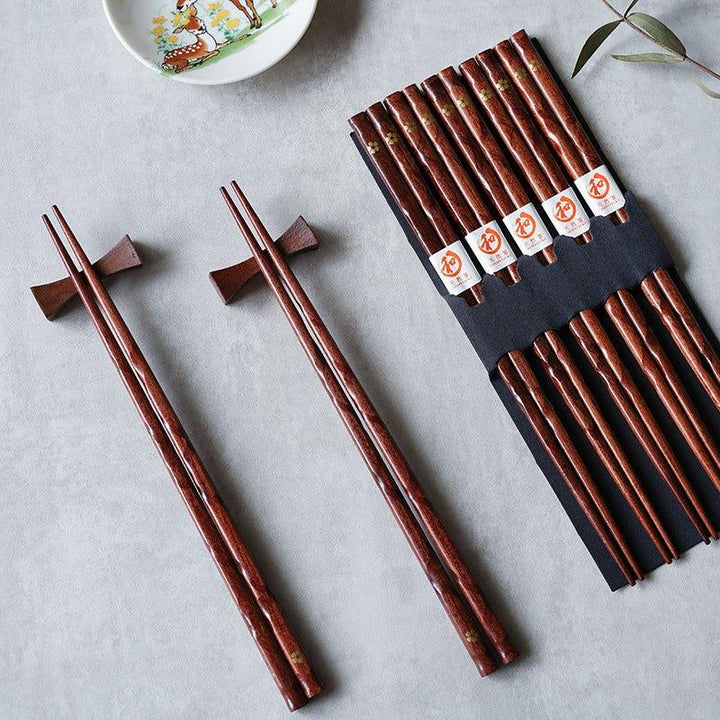 Elegant golden cherry blossom wood chopsticks, a beautiful 5-pair set for Japanese dining.