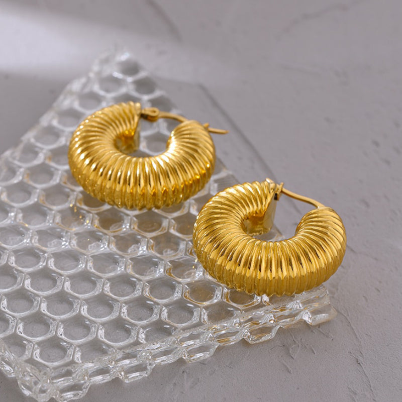 Women's delicate gold earrings. Stylish and elegant for everyday wear. Hypoallergenic fashion jewelry.