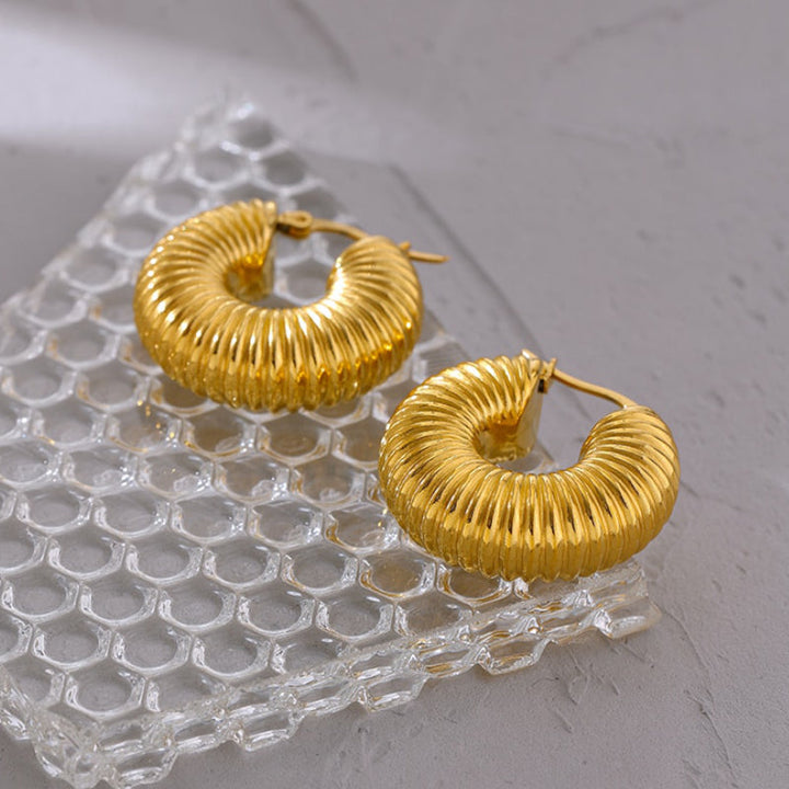 Women's delicate gold earrings. Stylish and elegant for everyday wear. Hypoallergenic fashion jewelry.