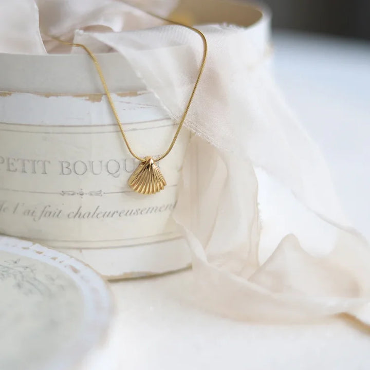 Sterling silver women's necklace, golden scallop flower with lilac detail, elegant and timeless jewelry.