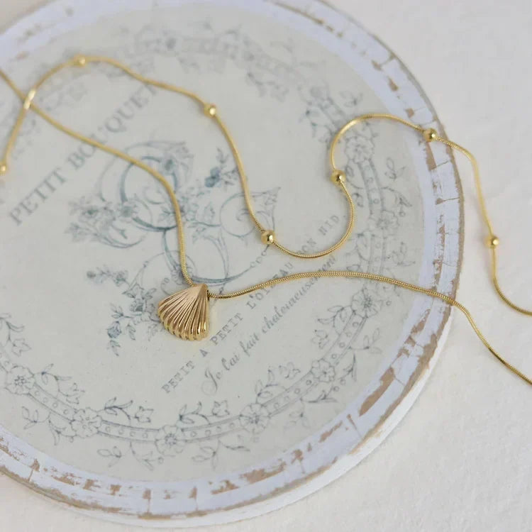 Women's lilac jewelry: Golden scallop flower pendant necklace, elegant and natural design for her.
