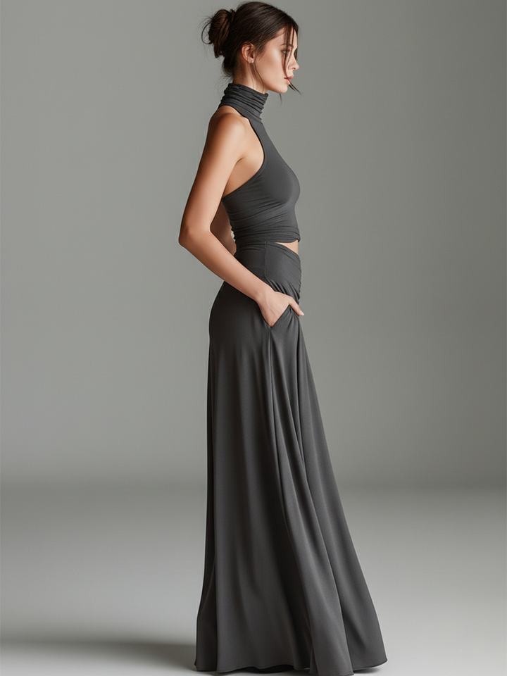 Flowing gray elegant maxi dress for women. Halter neck, stylish cutout, and a beautiful ruched skirt create a flattering silhouette.