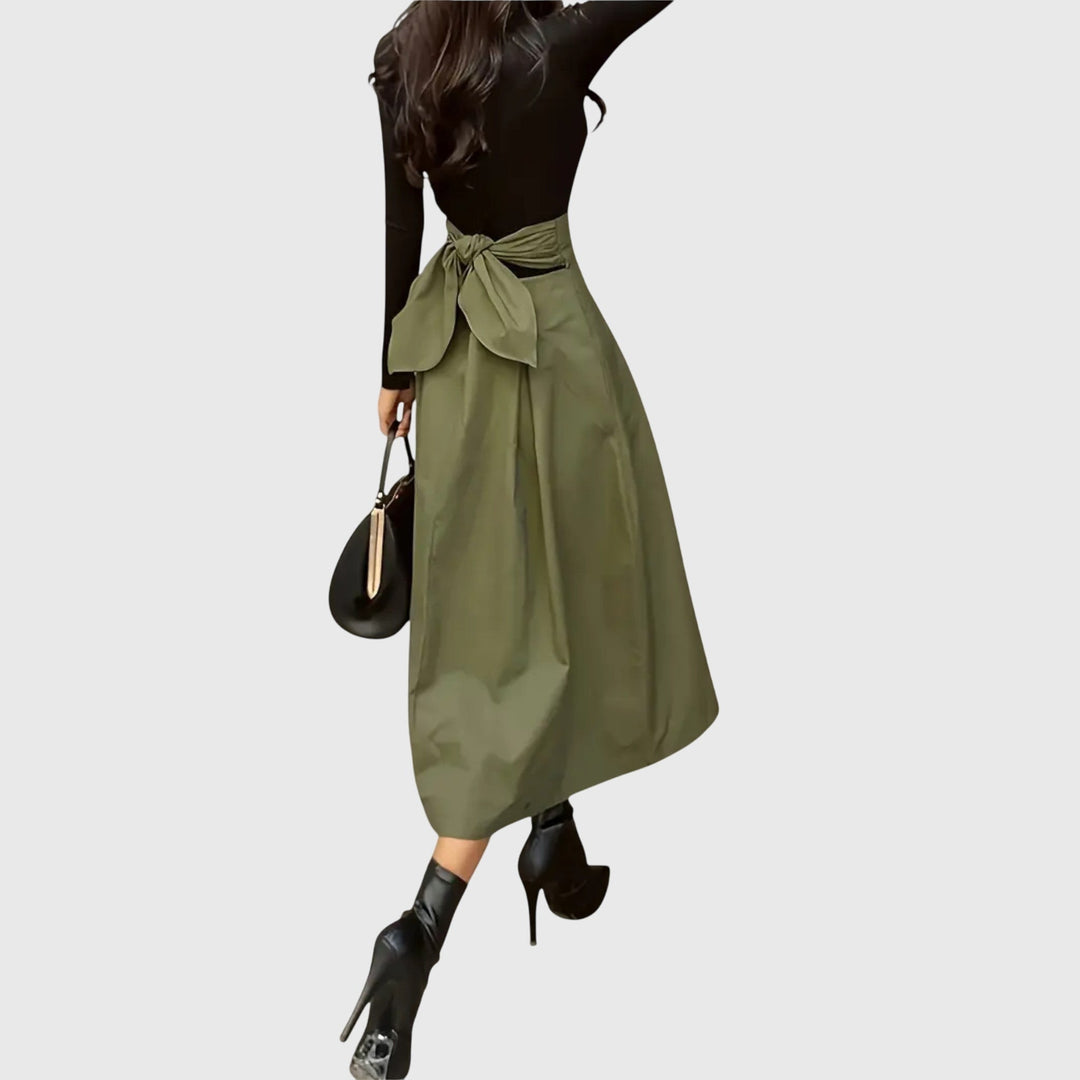 Women's versatile green A-line midi skirt, ideal for office fashion or elegant casual styling. A chic bottom.