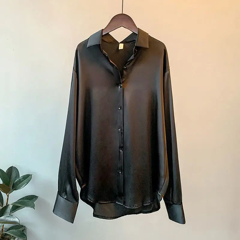 Stylish black women's collared top blouse, a classic long-sleeve shirt for any elegant occasion.