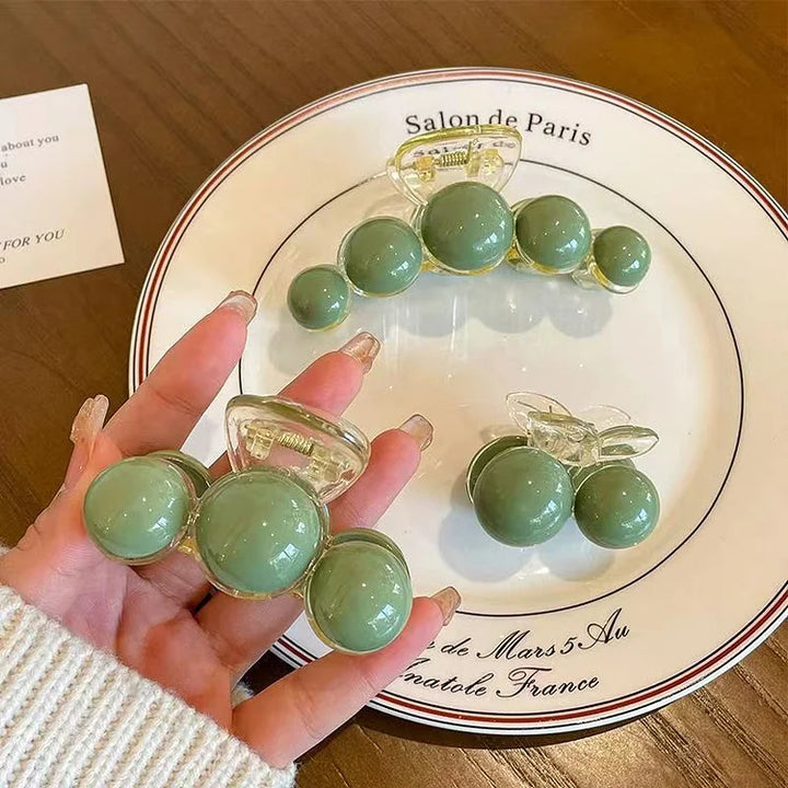 Stylish Liana green pearl hair clip, a fashionable gold accessory for women's hair and elegant updos.
