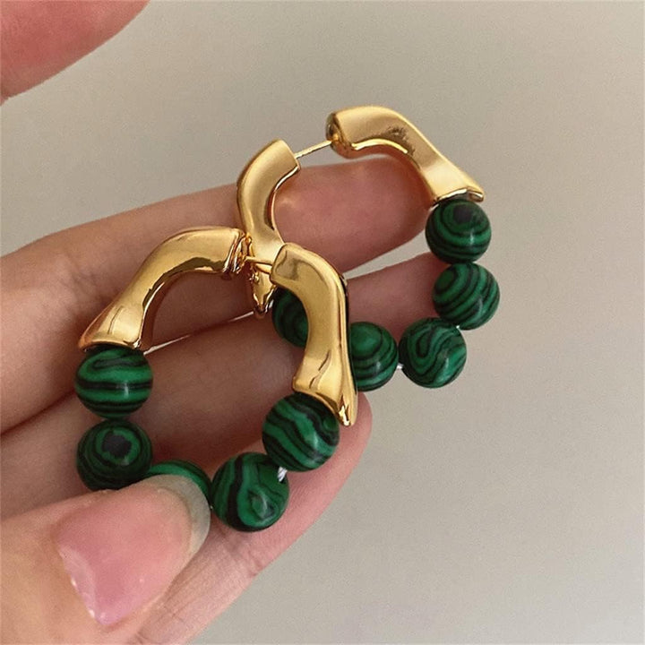 Elegant green pearl stud earrings for women, a timeless and delicate fashion accessory, perfect for any occasion.