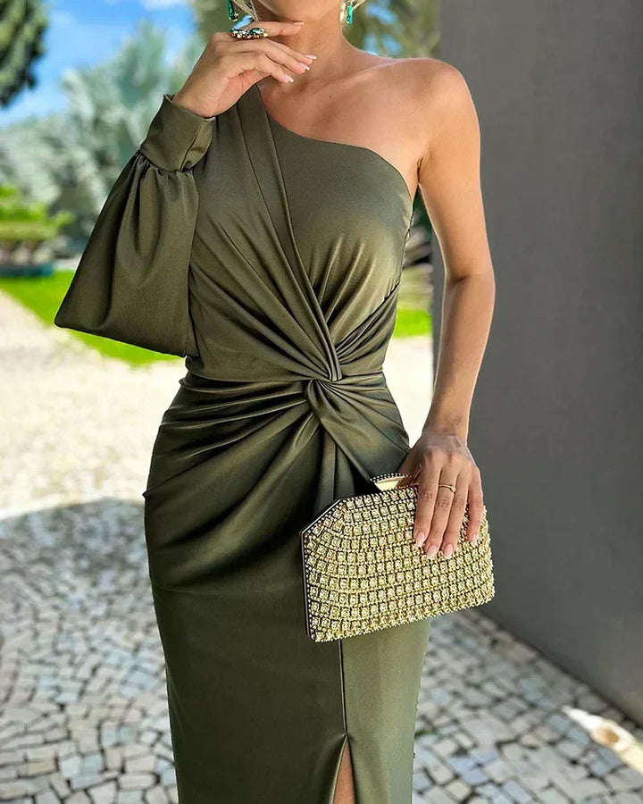 Close-up of a flowy green pleated dress for women, highlighting elegant texture and comfortable, modest style.