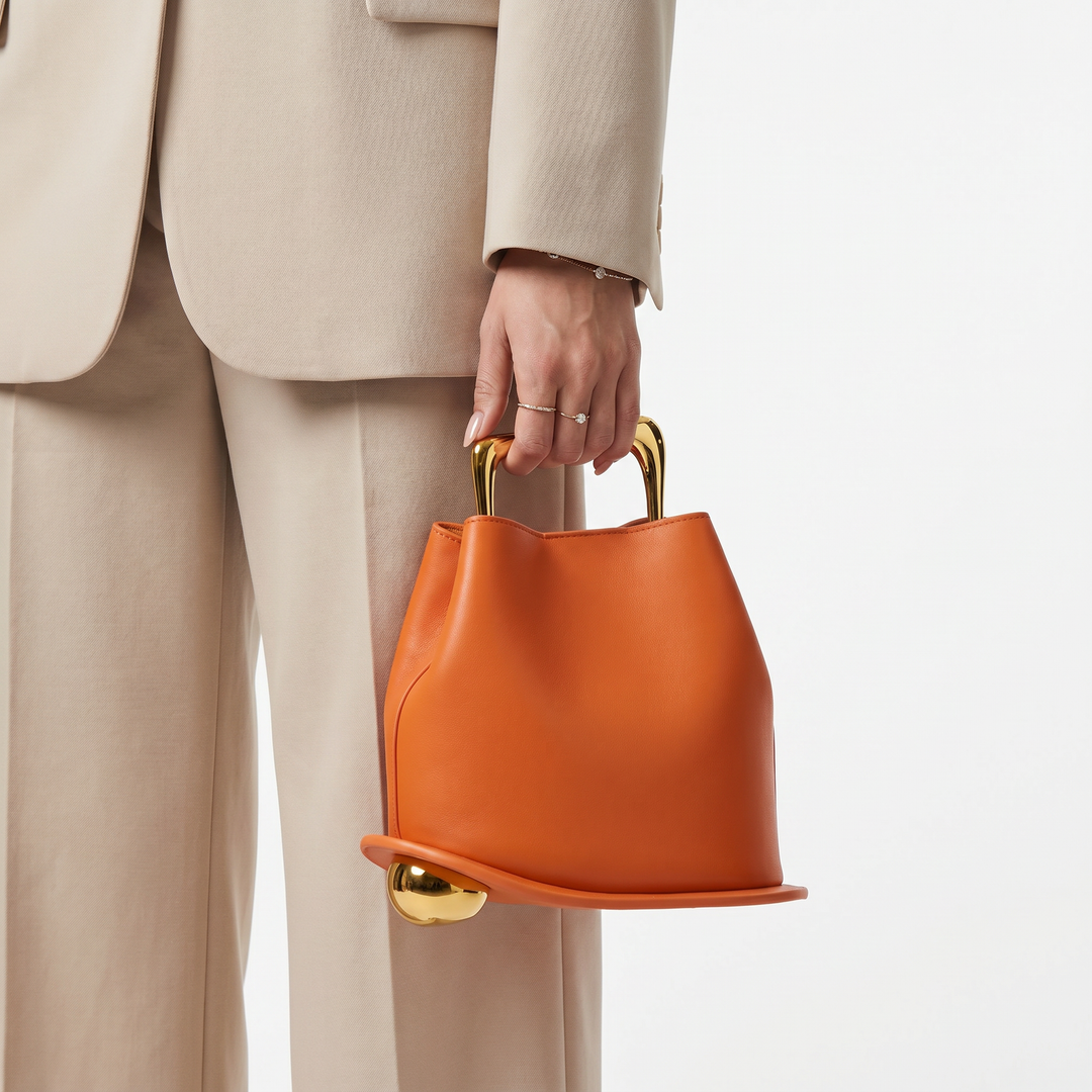 Stylish orange structured bucket bag, women's elegant daily carry PU leather handbag.