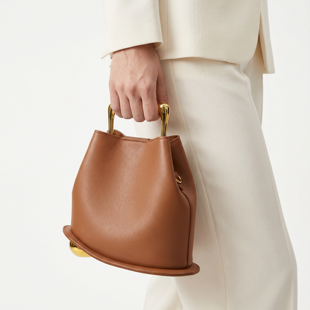 Versatile brown PU leather bucket bag, chic women's everyday structured handbag.