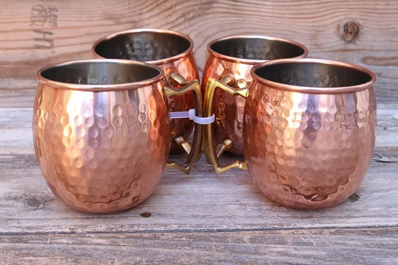 Elegant hammered copper mug set for Moscow Mules & chilled cocktails. Premium barware, kitchen essential.