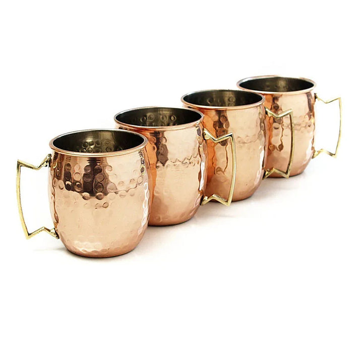 Gift-ready elegant hammered copper mug set. Essential barware for any cocktail enthusiast.