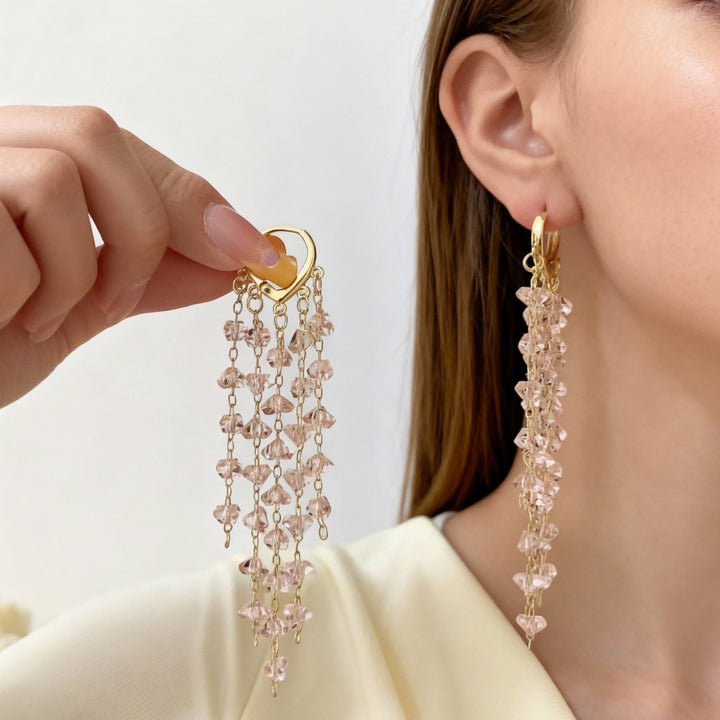 Close-up of sparkling irregular crystal tassel dangle earrings, chic women's jewelry for parties.