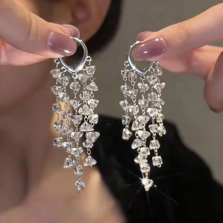 Fashionable women's irregular crystal earrings with flowing tassels, ideal elegant dangle party accessory.