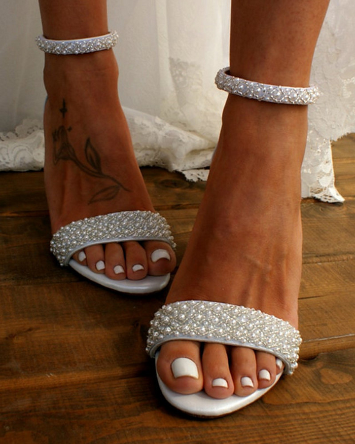 Comfortable women's bridal heels, ivory, with elegant delicate straps and secure ankle closure, perfect wedding footwear.