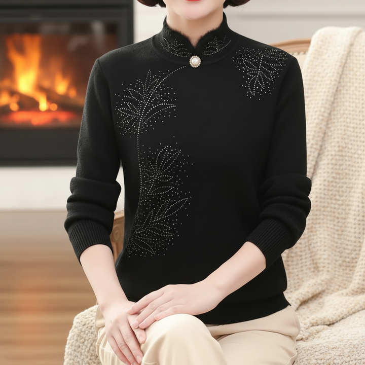 Elegant knitted high collar sweater for women, showcasing a delicate floral pattern in a wool blend.