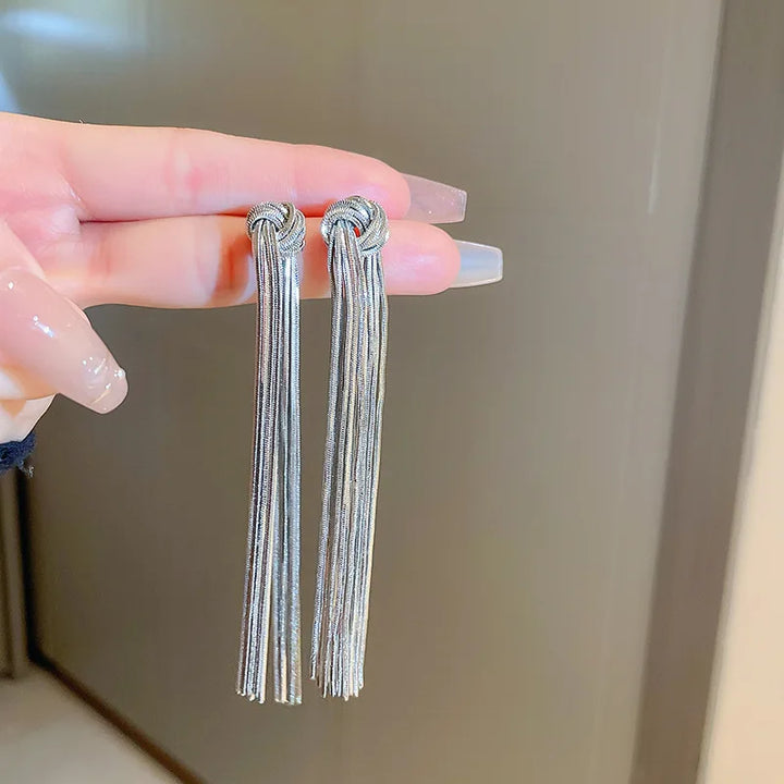 Statement women's long tassel earrings with intricate knot detail, adding a touch of elegance.