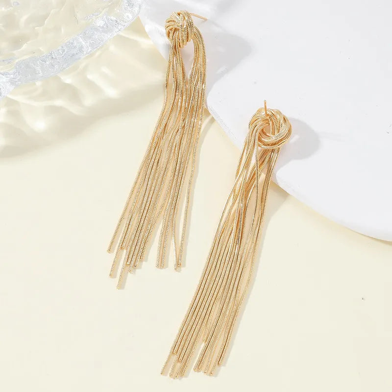 Fashionable women's elegant metallic-tone knot long tassel earrings, perfect for any look.