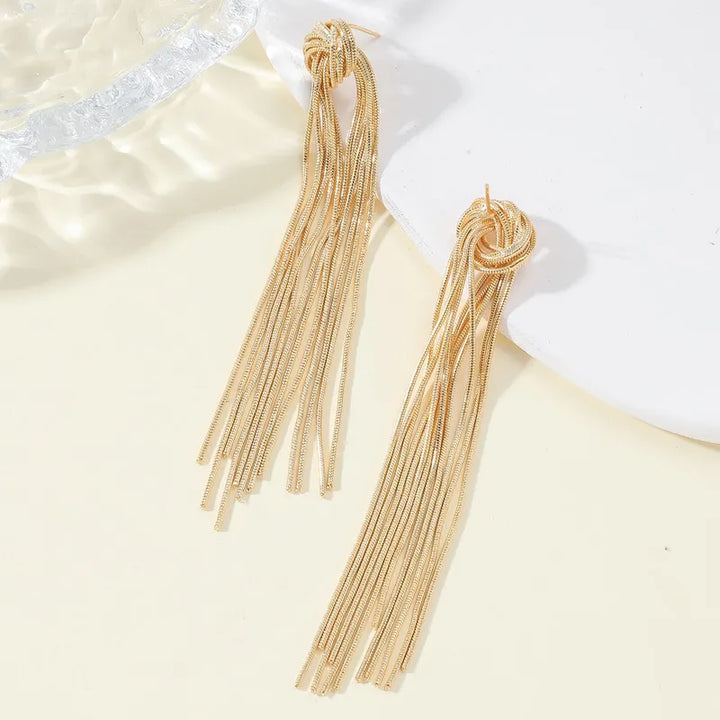 Fashionable women's elegant metallic-tone knot long tassel earrings, perfect for any look.