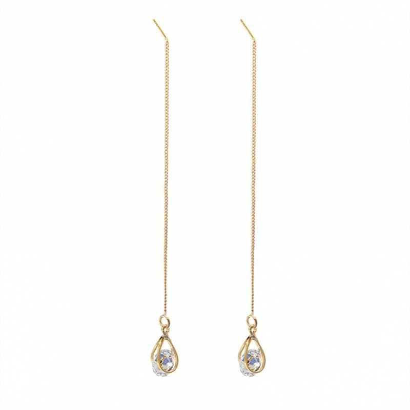 Close-up of intricate long drop rhinestone dangle earrings, elegant womens fashion accessory.
