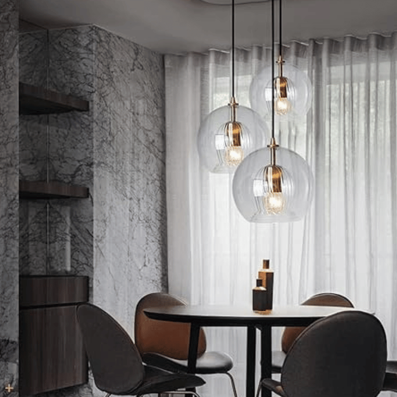 Versatile modern pendant lamp, adjustable, aluminum, glass, for various home spaces and decor.