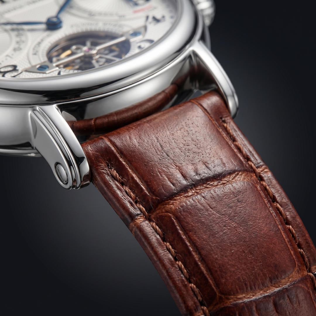 Classic men's automatic watch with a silver-tone case, deep blue dial, and comfortable brown leather strap.