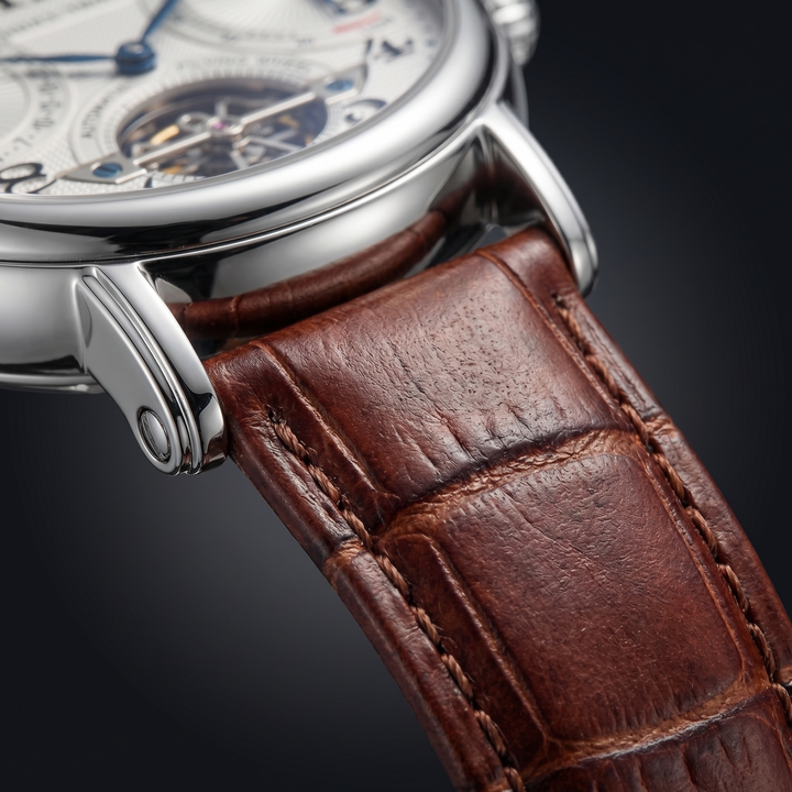 Classic men's automatic watch with a silver-tone case, deep blue dial, and comfortable brown leather strap.