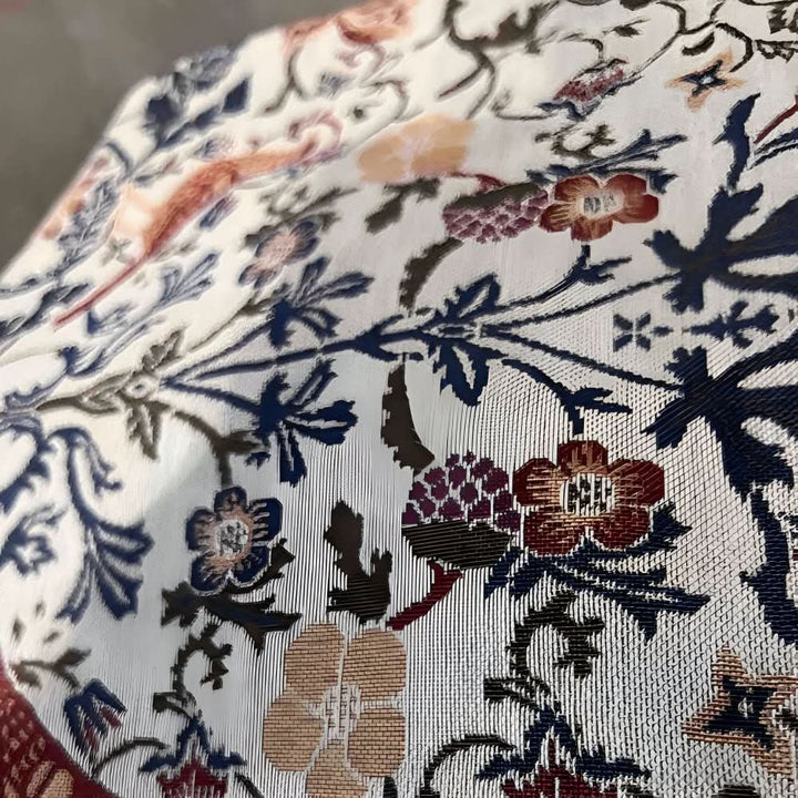 Beautiful microfiber table runner with a vibrant floral bird motif, enhancing any dining room decor with elegance.