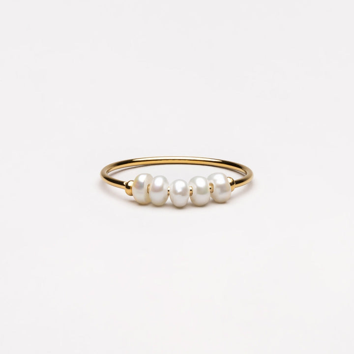 Elegant mini pearl ring for women, featuring dainty freshwater pearls on a delicate band.