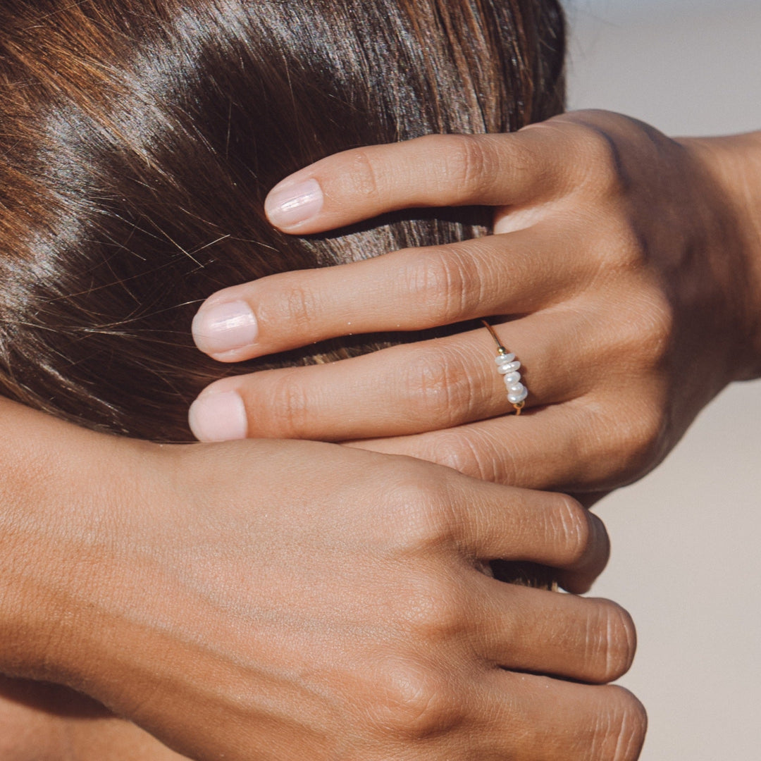 Women's elegant pearl ring with small freshwater pearls, a trendy and hypoallergenic jewelry piece.
