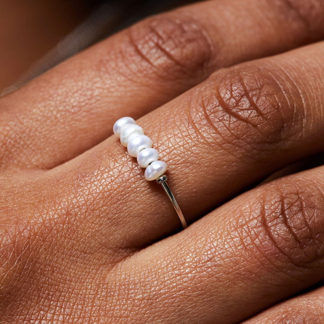 Elegant women's pearl ring, delicate design with real freshwater pearls, available in gold and silver.
