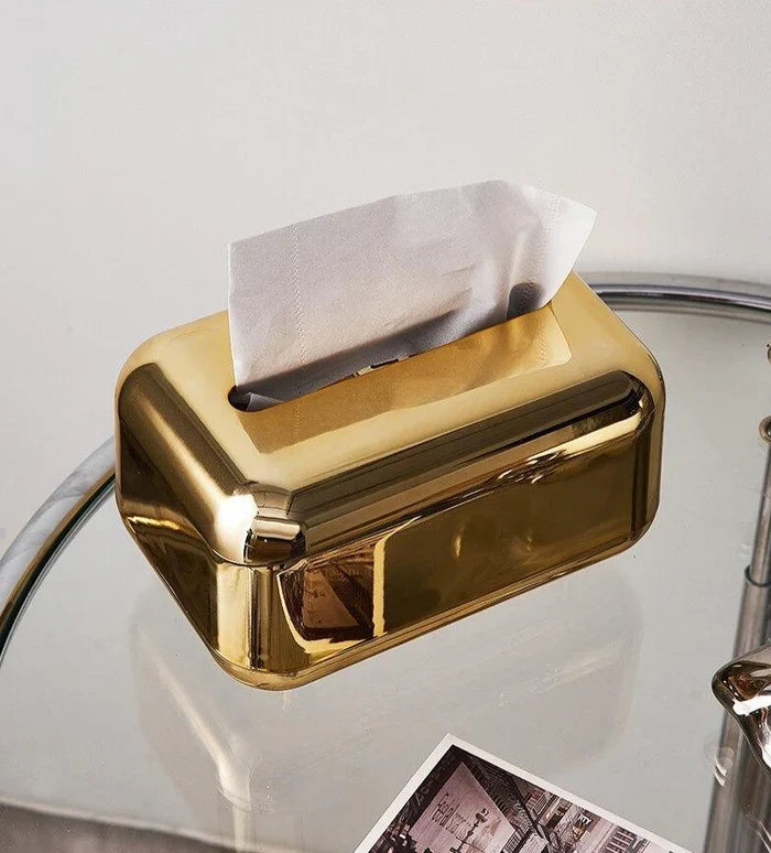 Gold finish tissue box holder, a striking modern tabletop organizer for luxury decor.