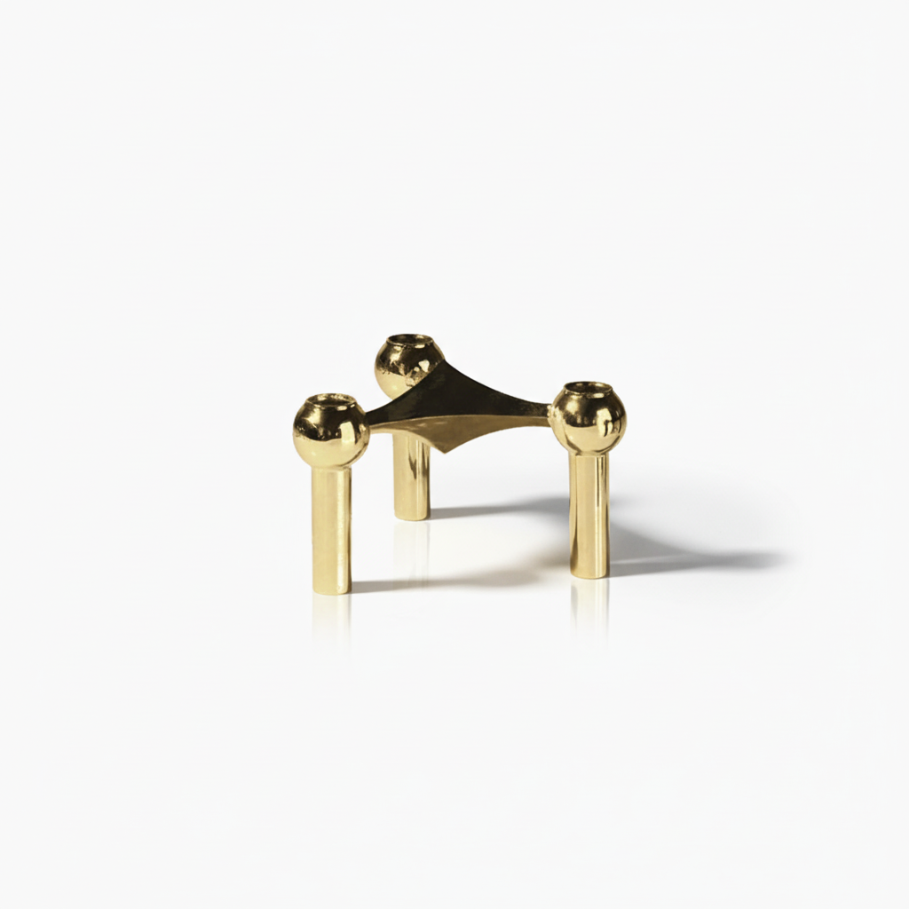 Artistic modular candle holders, sculptural table decor, stainless steel accents.