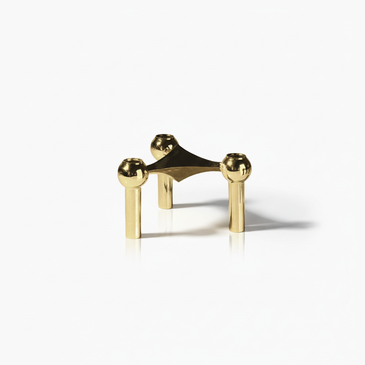 Artistic modular candle holders, sculptural table decor, stainless steel accents.