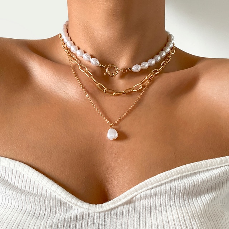 Woman wearing an elegant multi-layer pearl necklace, a timeless and classic fashion statement.