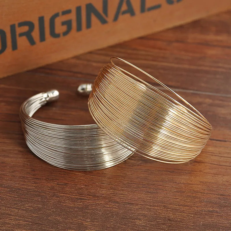 Stackable & adjustable multi-strand bracelet in gold. Elegant women's fashion jewelry.