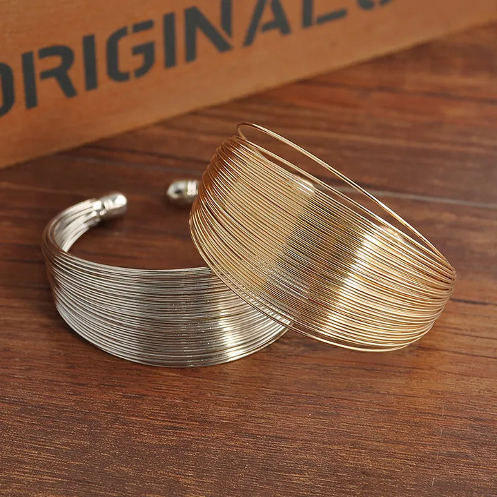 Stackable & adjustable multi-strand bracelet in gold. Elegant women's fashion jewelry.