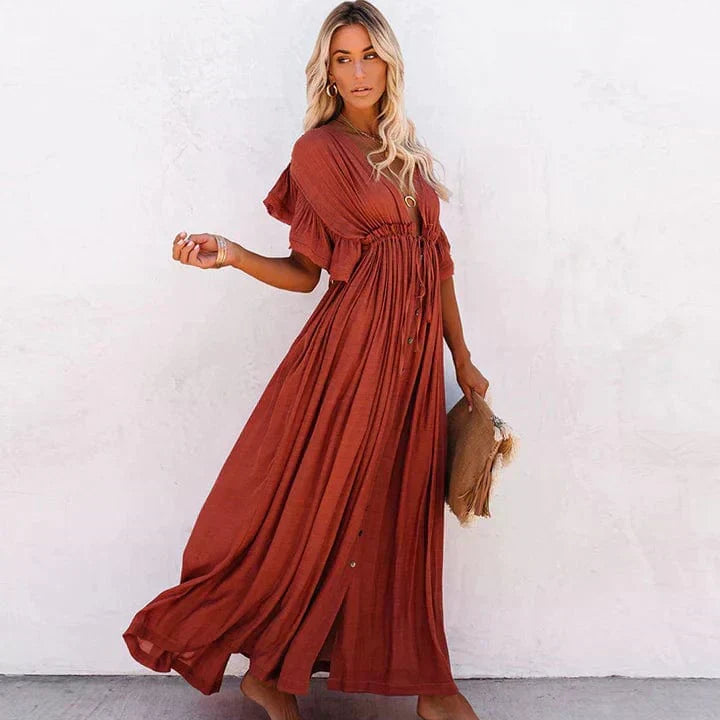 Stylish flowy long orange summer dress for women, comfortable elegant beachwear.