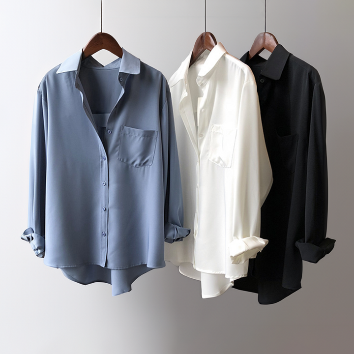 Sophisticated pastel blue women's blouse, featuring a flowing silhouette, long sleeves, and a stylish high-low hem.