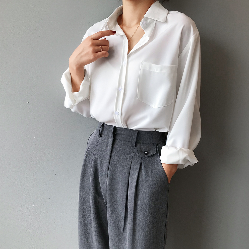Women's elegant pearl white blouse with a stylish high-low hem and flowing long sleeves, perfect for office wear.
