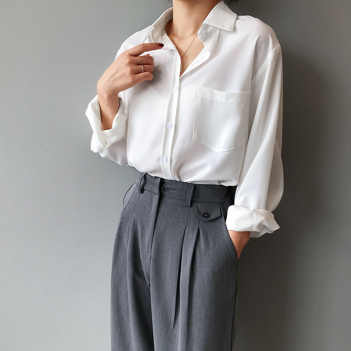 Women's elegant pearl white blouse with a stylish high-low hem and flowing long sleeves, perfect for office wear.